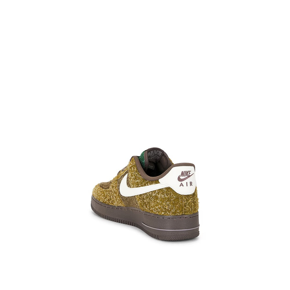 Back view low-top sneakers with gold speckled upper, white swoosh, and dark sole