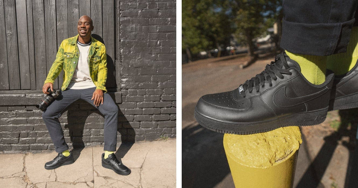 Black low-top sneakers with lace-up closure and yellow pant cuffs