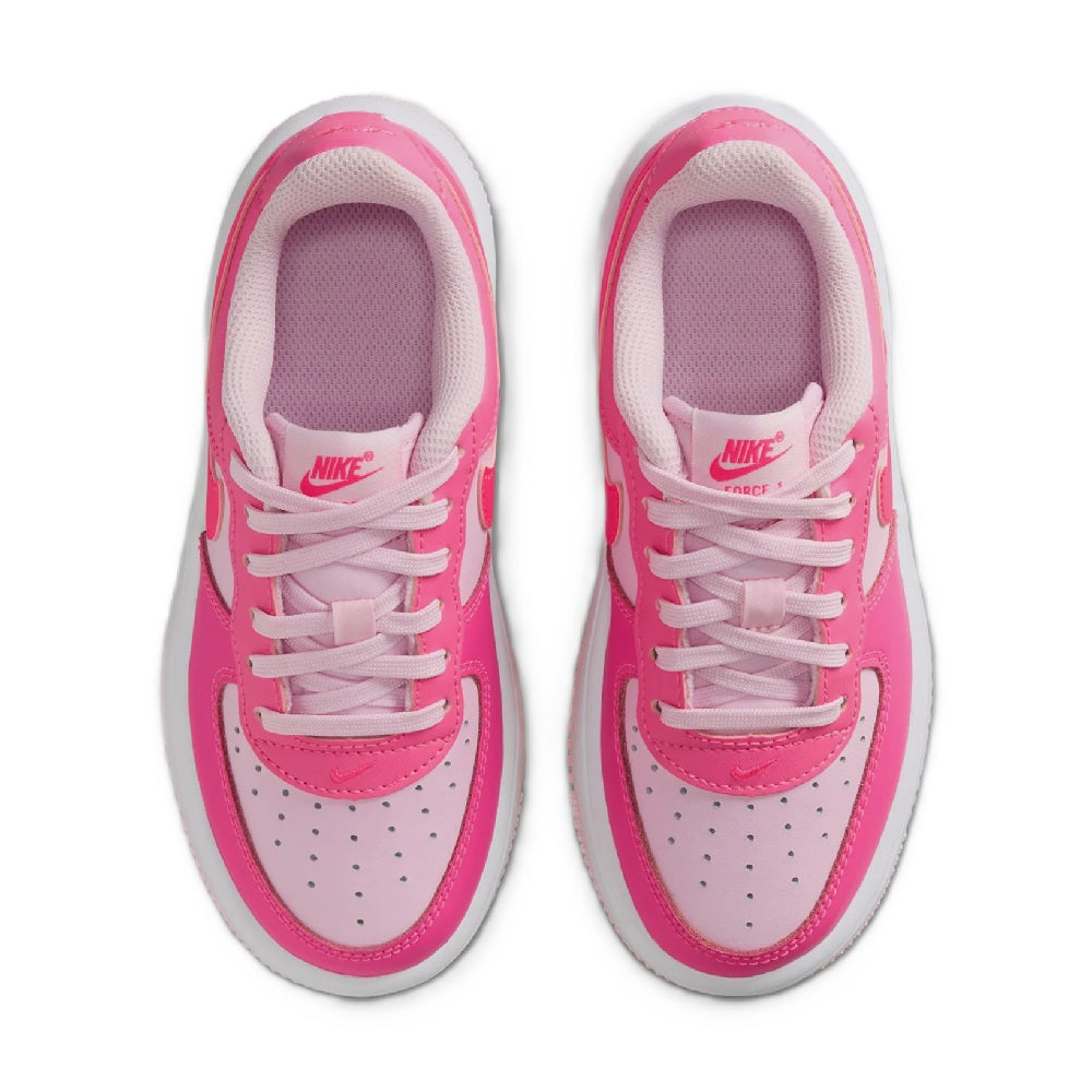 Pair of kids sneakers showing lace-up tongue and pink lining inside