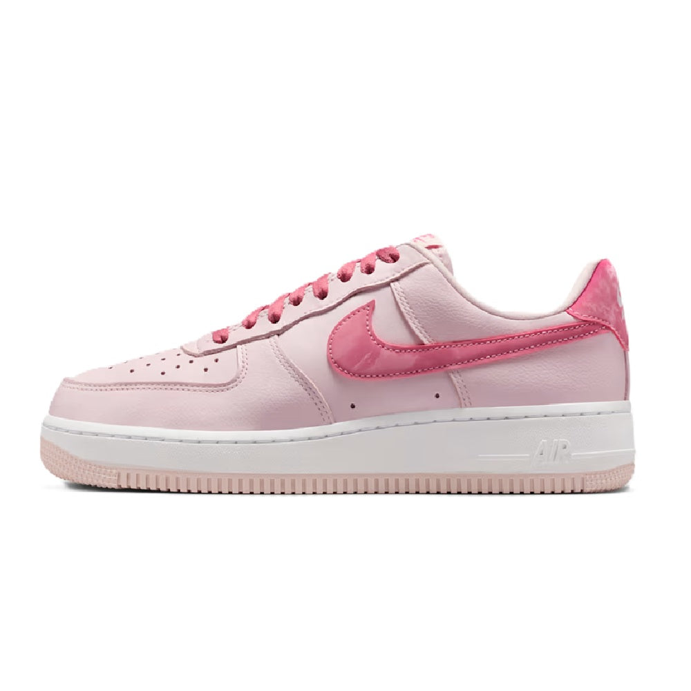 Women’s Nike Air Force 1 low-top sneakers in pale pink and white, lace-up side view