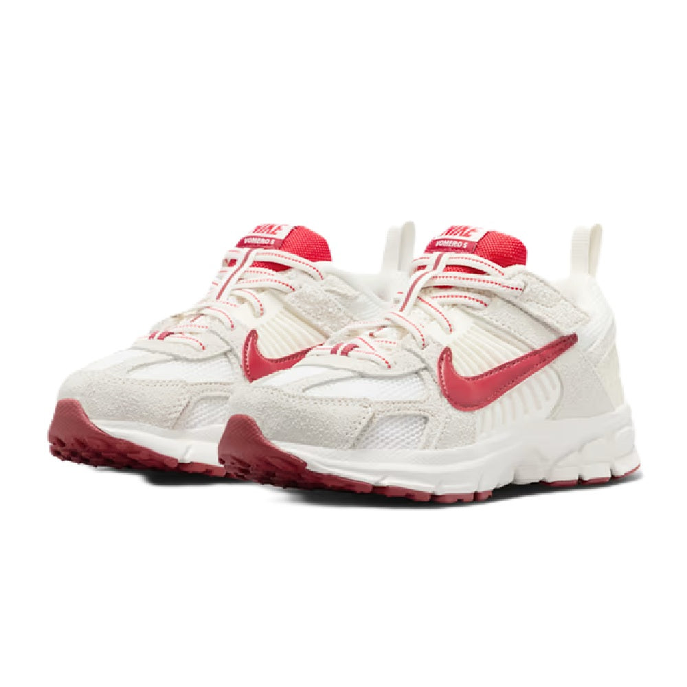 Kids' Nike Vomero 5 SE sneakers pair, white knit upper with red accents and laces.