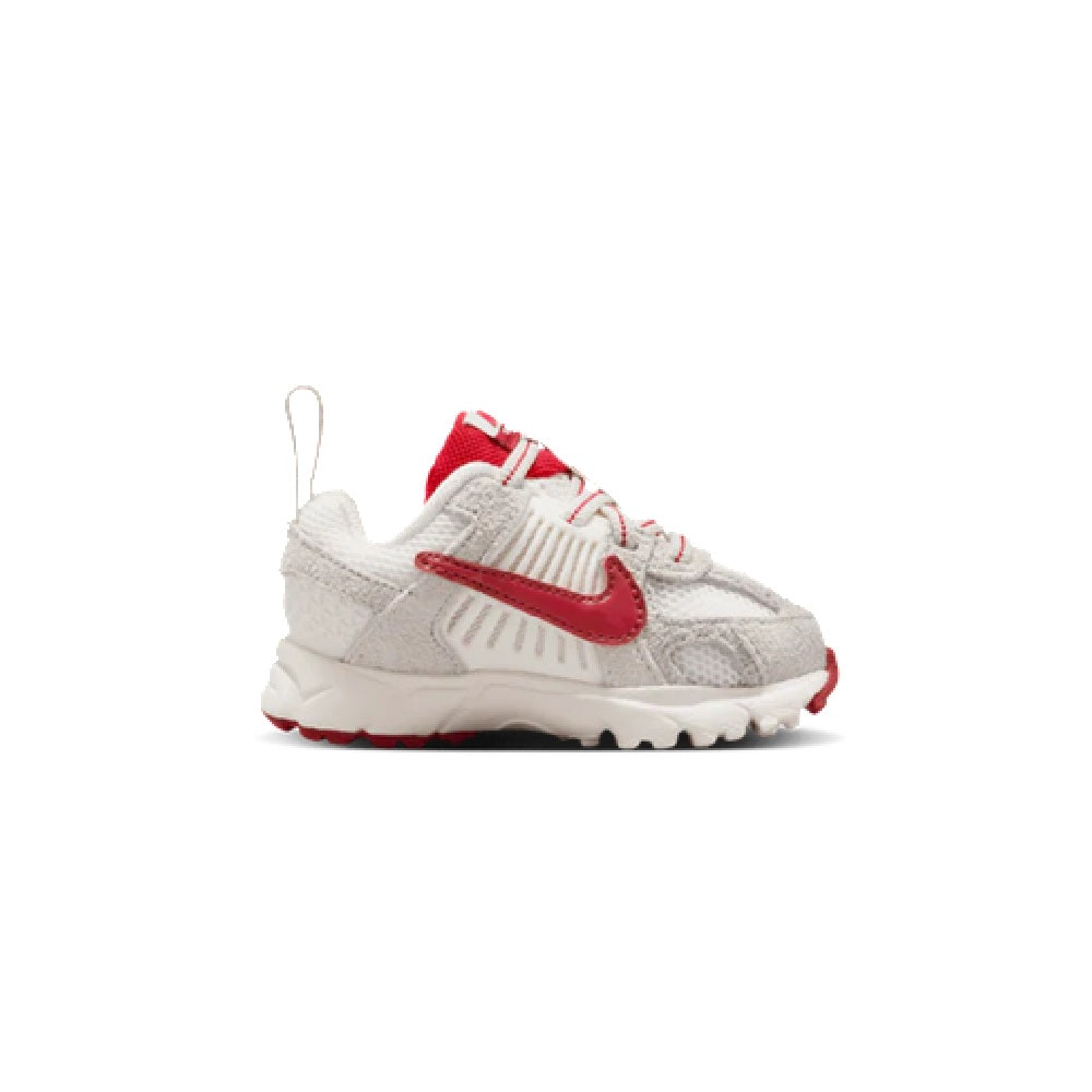 Toddler Nike running shoes in white with red swoosh, lace-up and cushioned sole