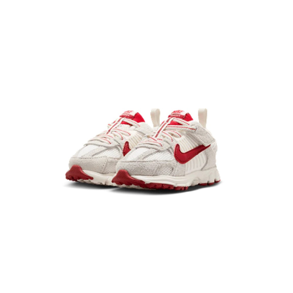 Toddler Nike running shoes front view, white upper with red accents and swoosh
