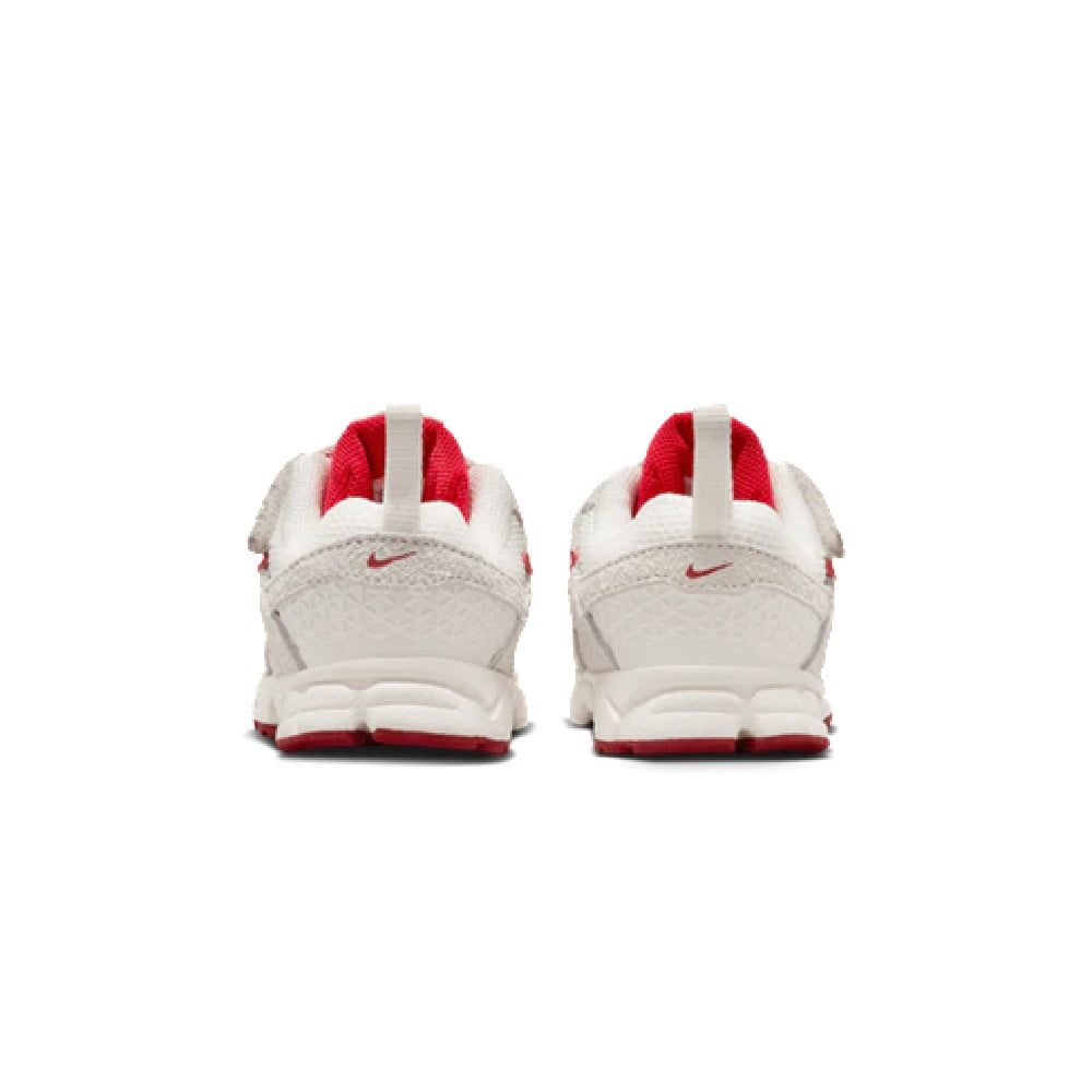Toddler Nike running shoes back view, white heel with red pull tabs and collar
