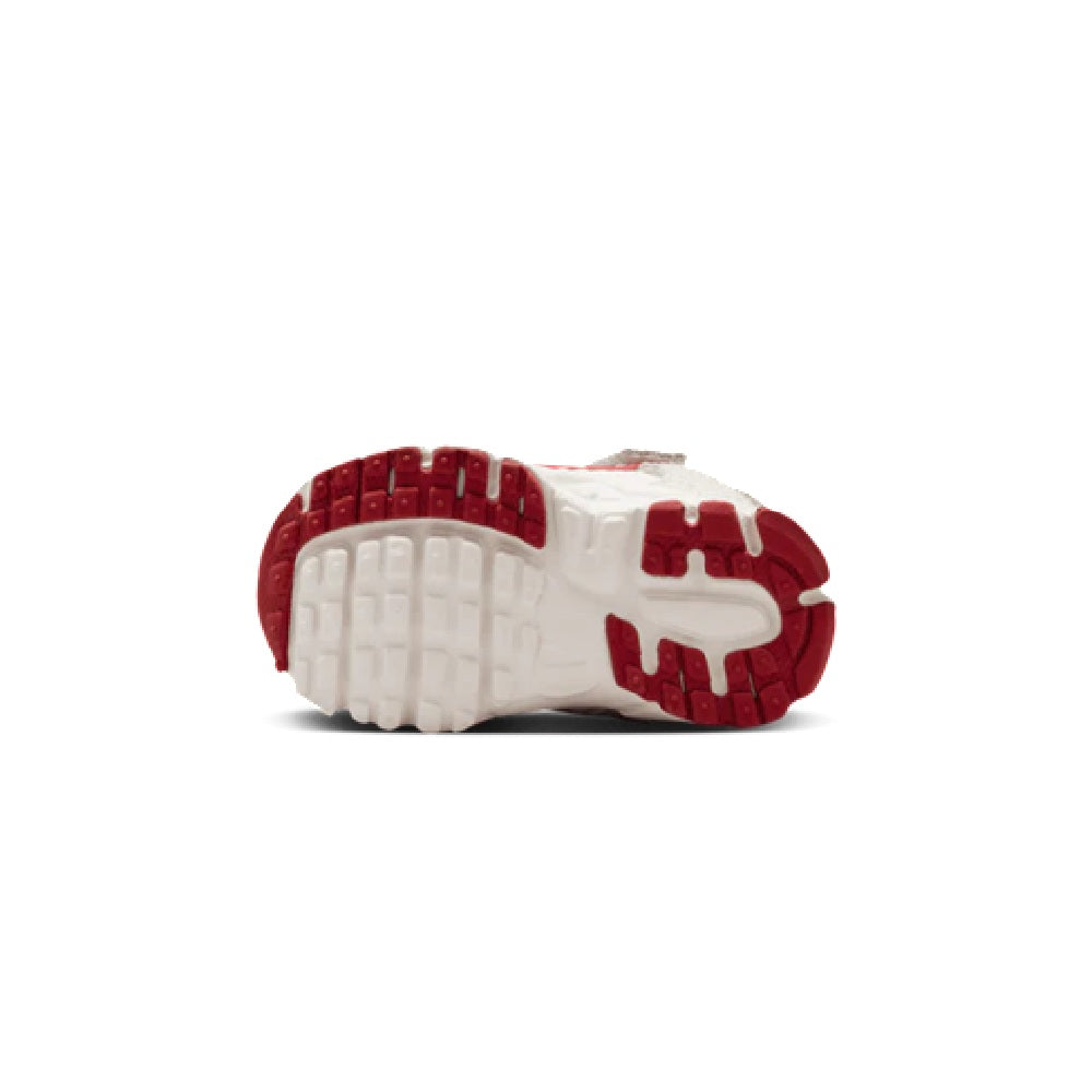 Toddler Nike running shoe outsole, white tread with red rubber details