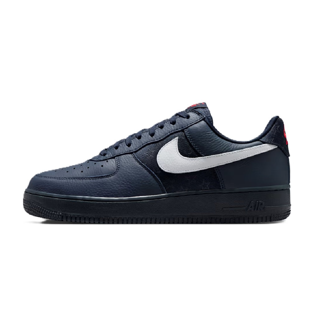 Navy low-top Nike sneaker with white swoosh, lace-up, and black Air midsole
