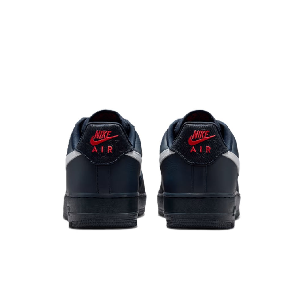 Back view of navy Nike Air Force 1 low-top sneakers with white heel accents