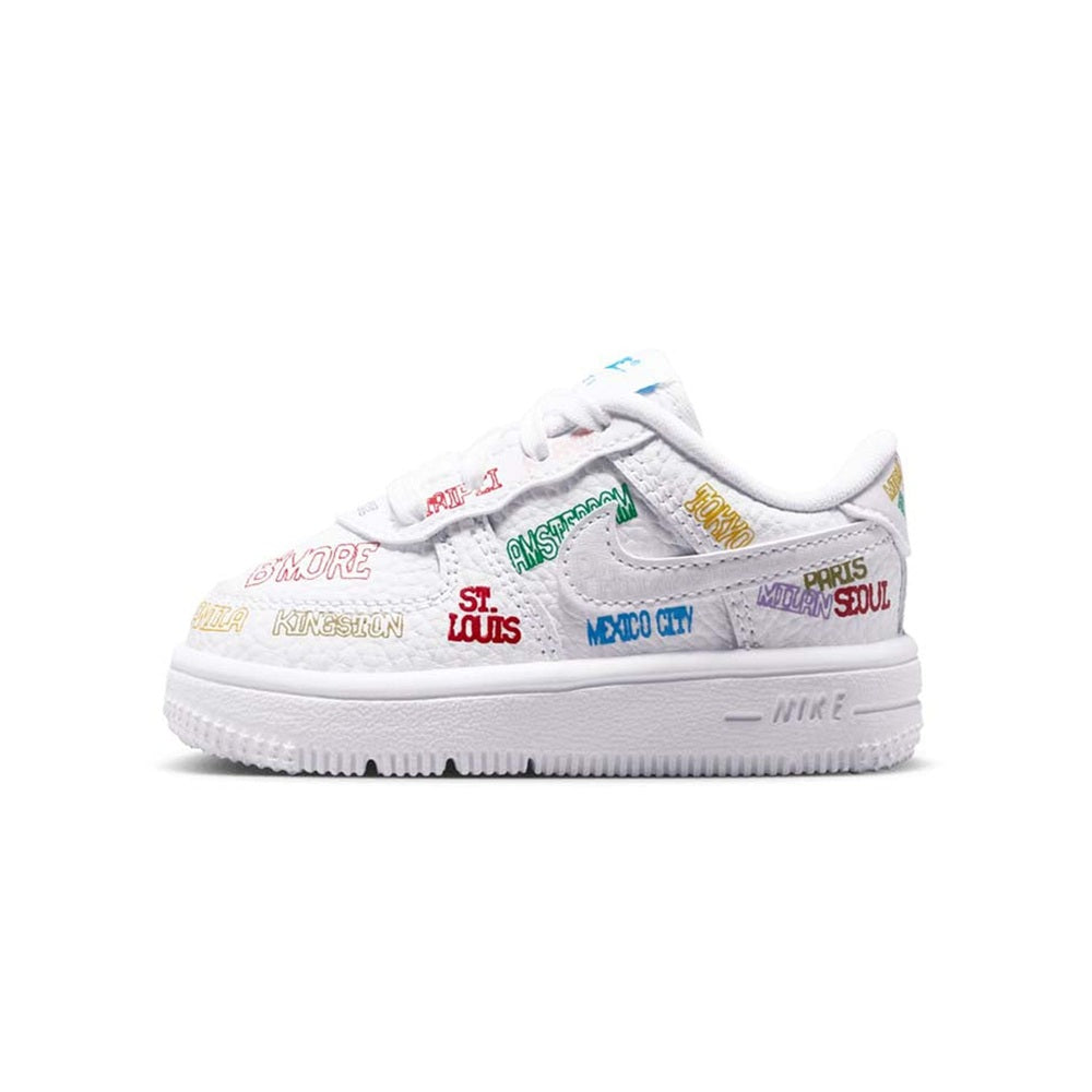 Toddler low-top Nike Air Force 1 sneakers in white with multicolor side text.