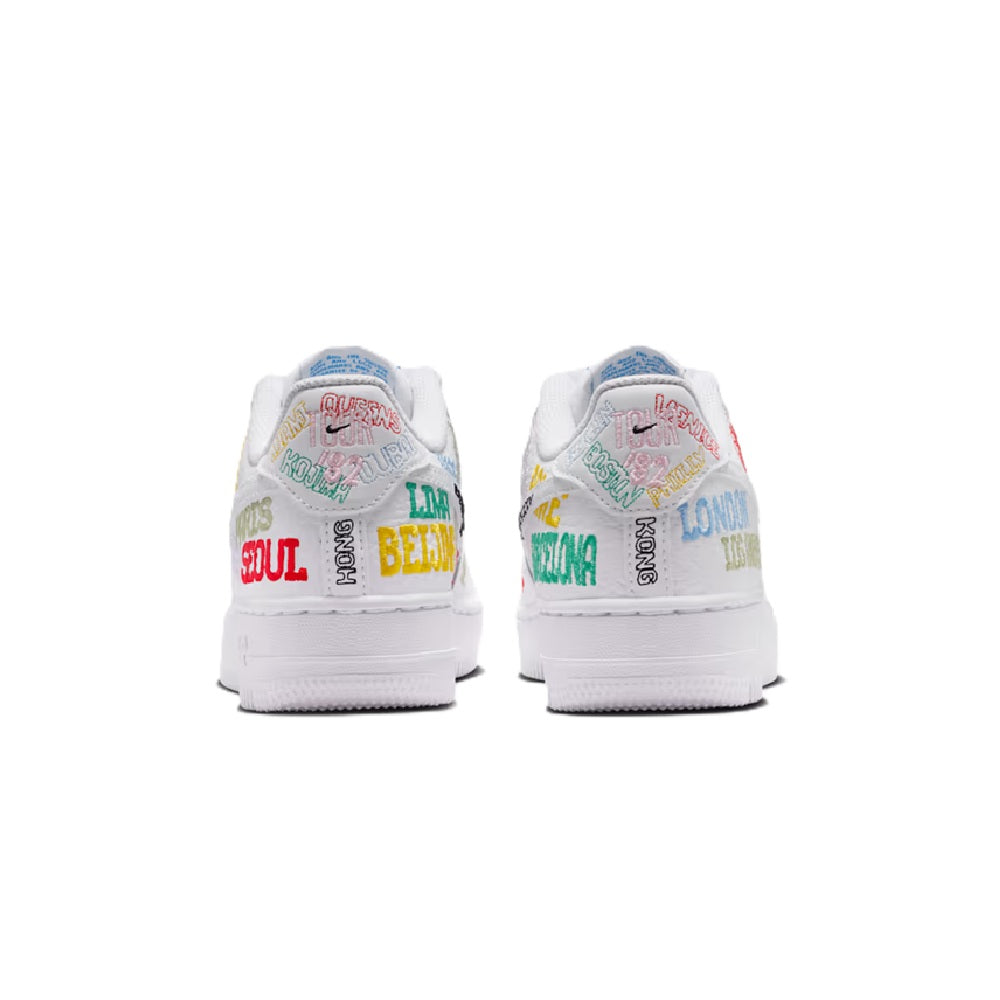 White low-top kids sneaker heel view with multicolor text graphics on back