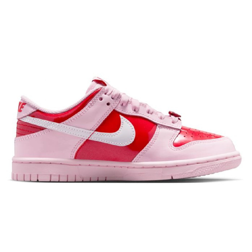 Pink and red low-top kids sneakers with white swoosh and lace-up front.
