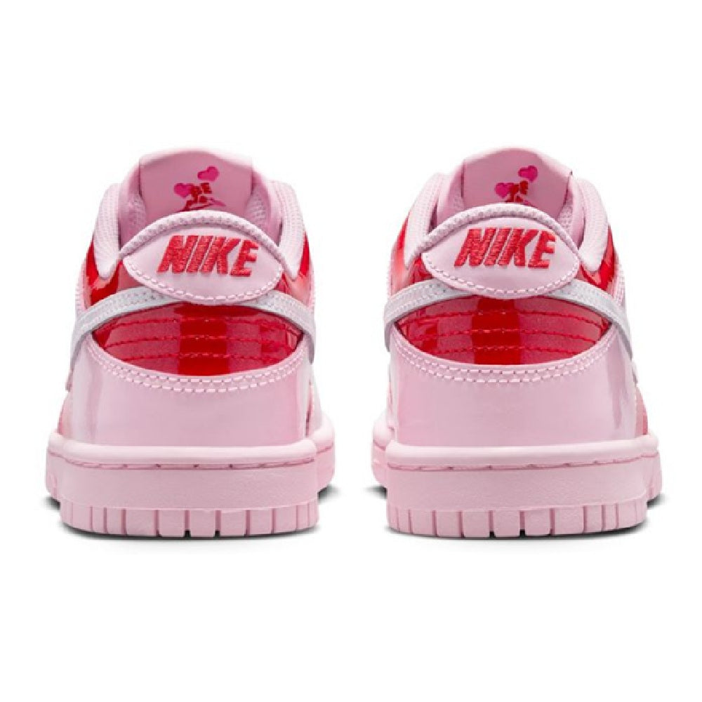 Pink low-top sneakers with rear heel tabs, Nike branding, and lace-up closure.