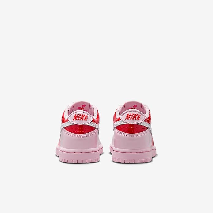 Kids sneakers with pink heel and tongue, red Nike branding, and pink rubber sole