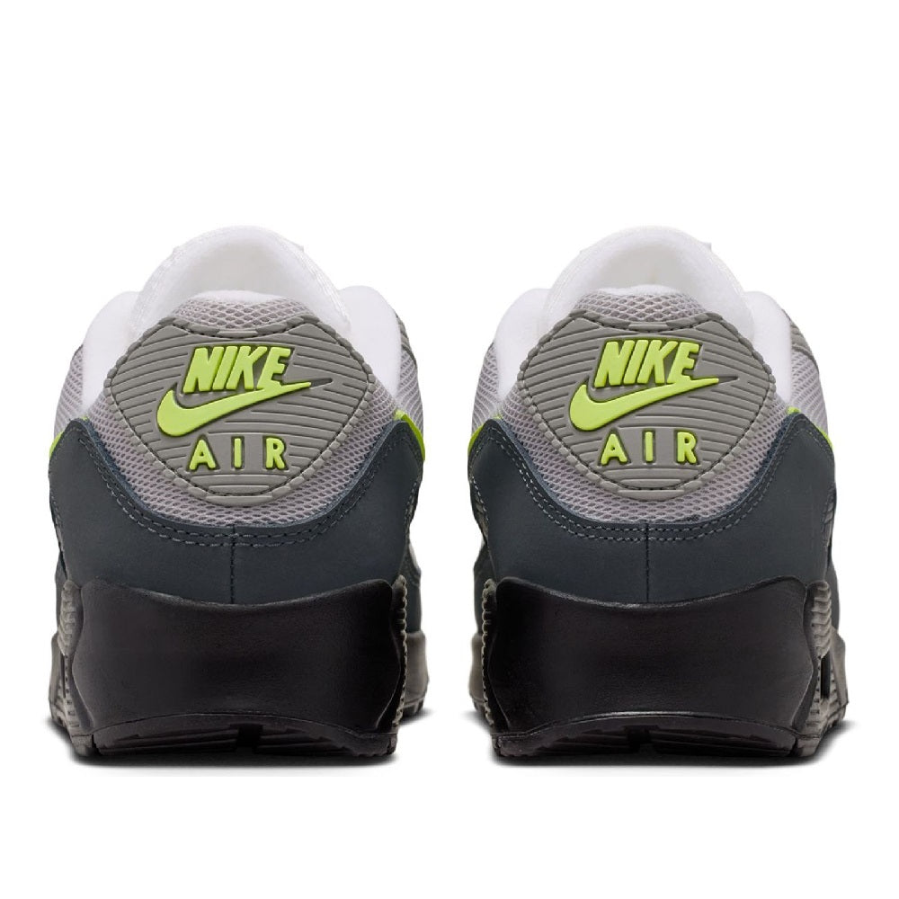 Back view of gray sneakers with Nike Air branding, neon yellow logo, and white heel tab