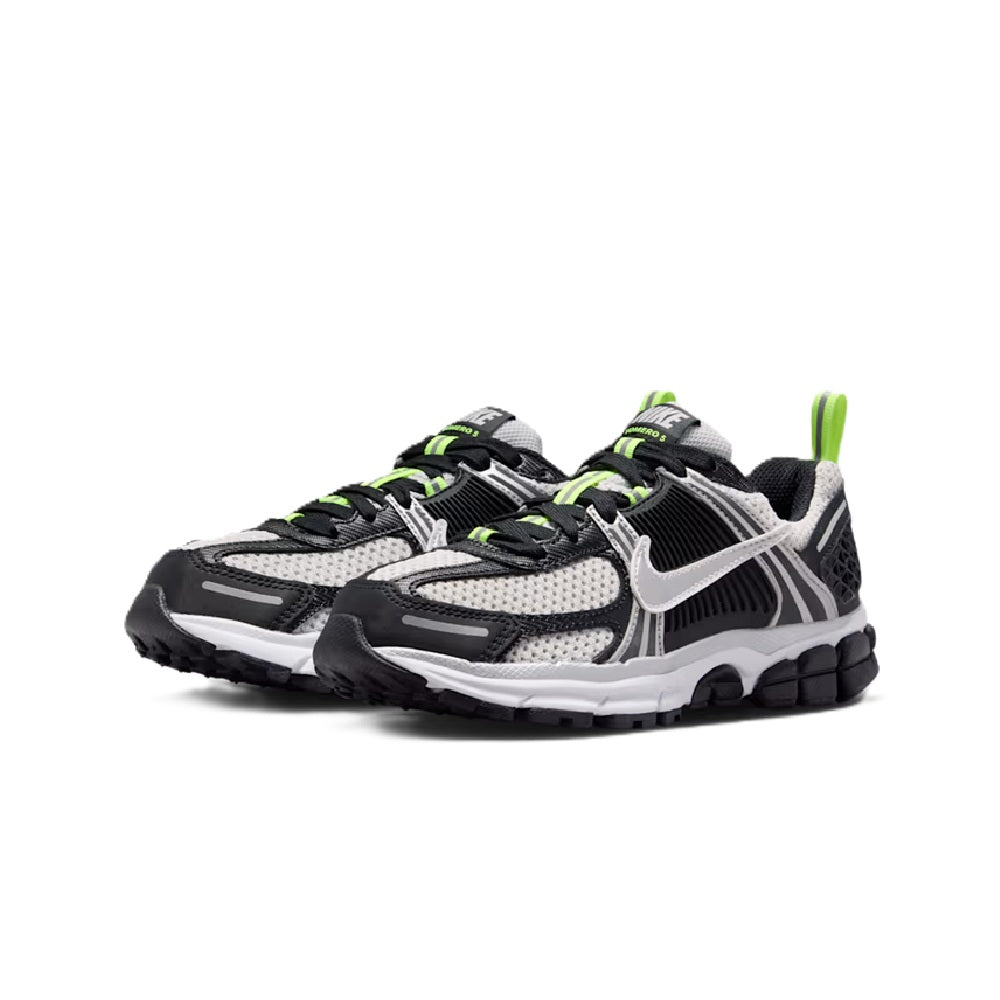 Big kid Nike Vomero 5 sneakers with black upper, metallic silver overlays, neon green laces