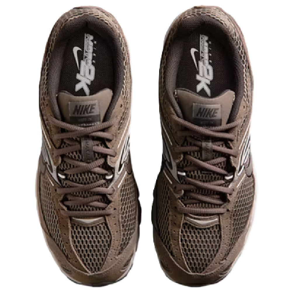 Brown Nike sneakers with lace-up front and black tongue lining with white logo