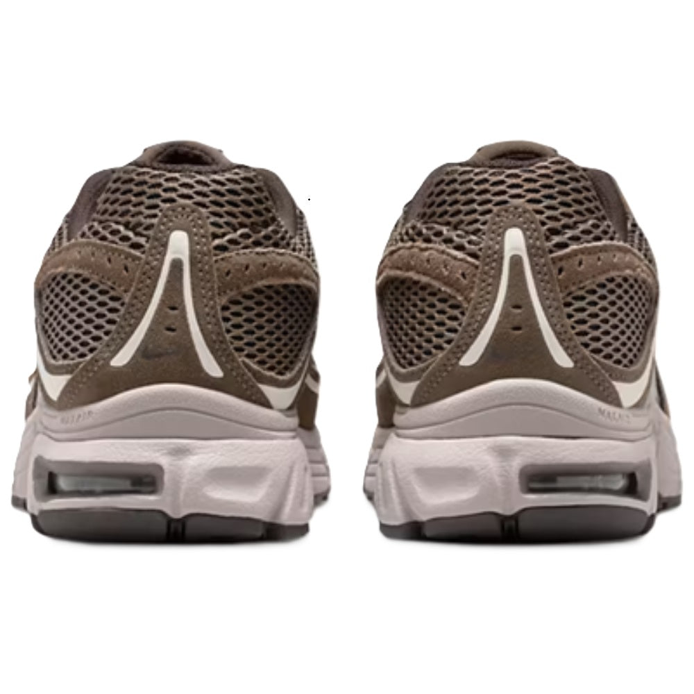 Brown sneakers with molded heel and white midsole, visible Air unit window
