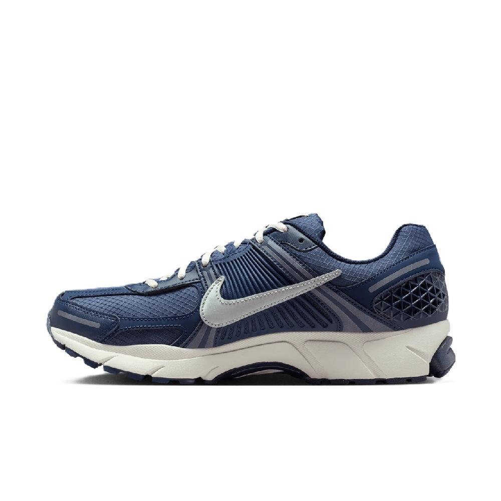 Men's Nike Zoom running shoe side profile in blue with silver swoosh and lace-up top
