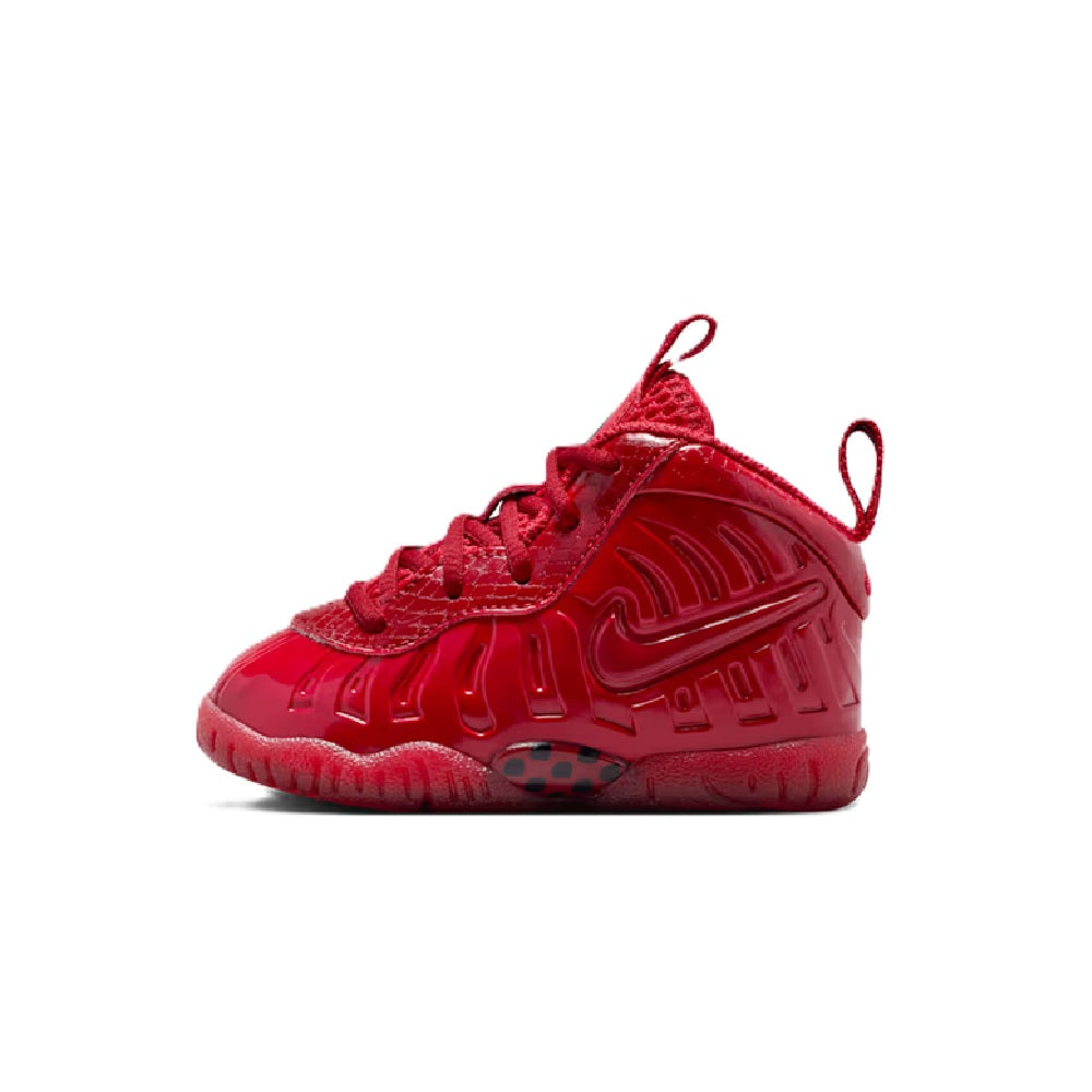 Toddler Nike Little Posite Pro mid-top sneaker in gym red with sidewall pattern detail.