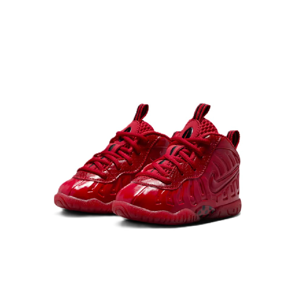 Toddler Nike Little Posite Pro pair of gym red sneakers with textured upper and laces.