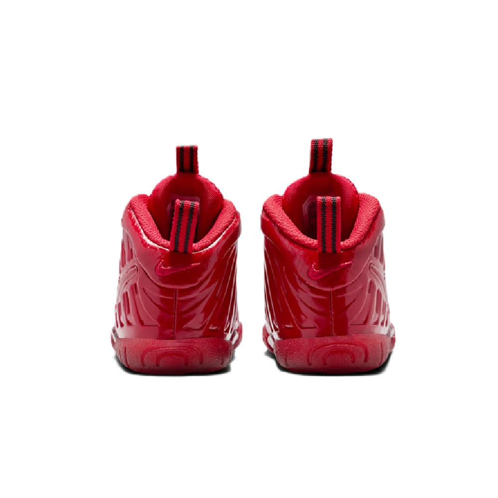 Toddler Nike Little Posite Pro sneakers showing heel tab and ridged back design in red.