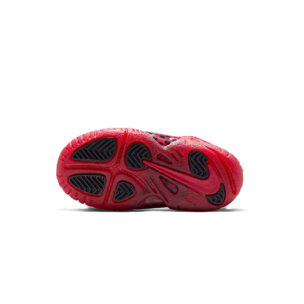Toddler Nike Little Posite Pro outsole view in gym red with rubber traction pods.