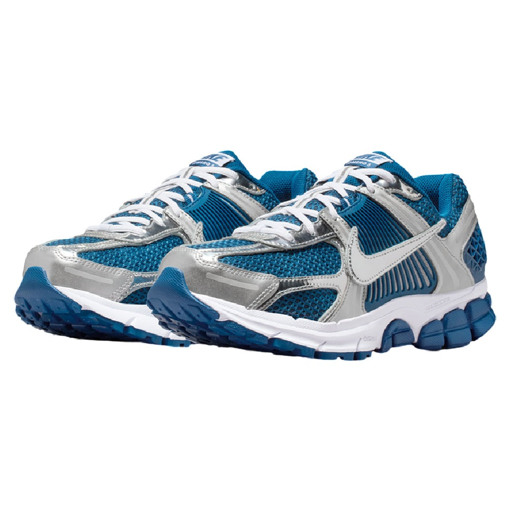 Pair of Nike Zoom Vomero 5 sneakers with white laces, blue mesh, and silver overlays