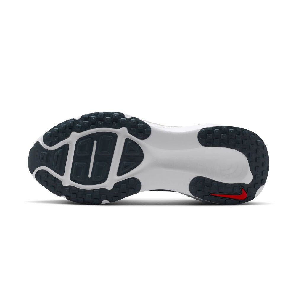 Outsole view of Nike running shoes with black rubber tread and white foam base.