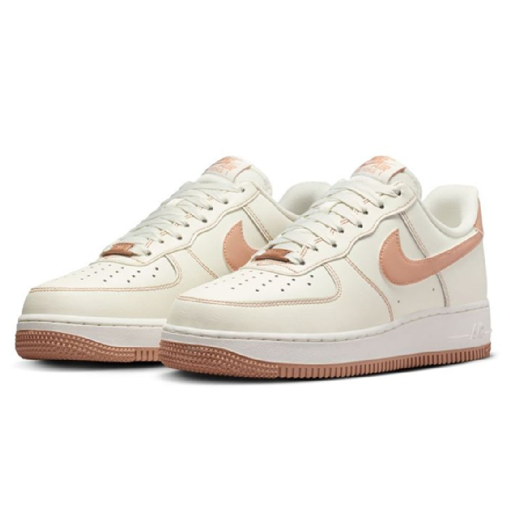 Nike Air Force 1 low-top sneakers pair in sail with rose gold accents and gum outsole