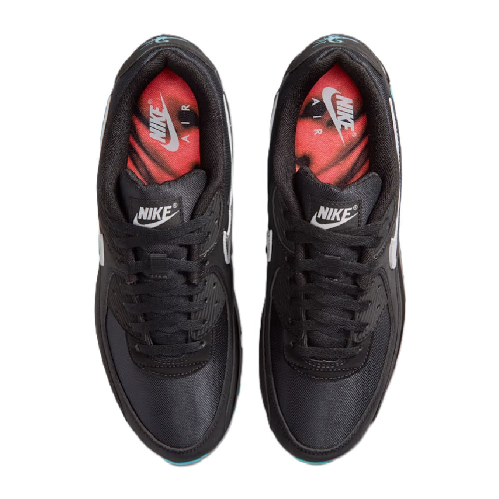 Black low-top sneaker showing red inner lining and Nike branding at tongue