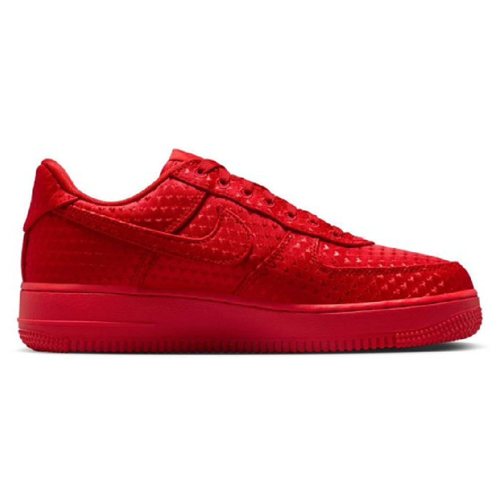 Red low-top Nike sneakers, side view with swoosh logo and textured upper