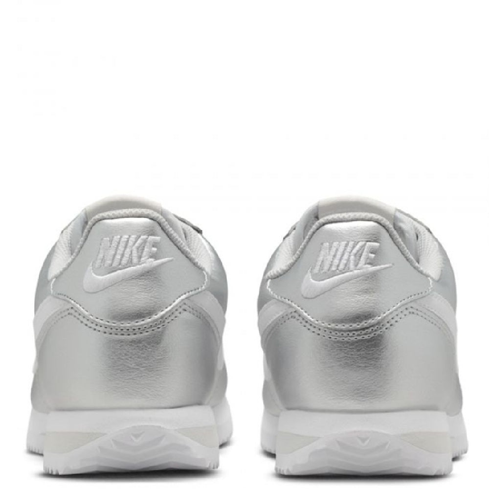Nike Cortez sneakers in metallic silver with Nike heel branding and white outsole.