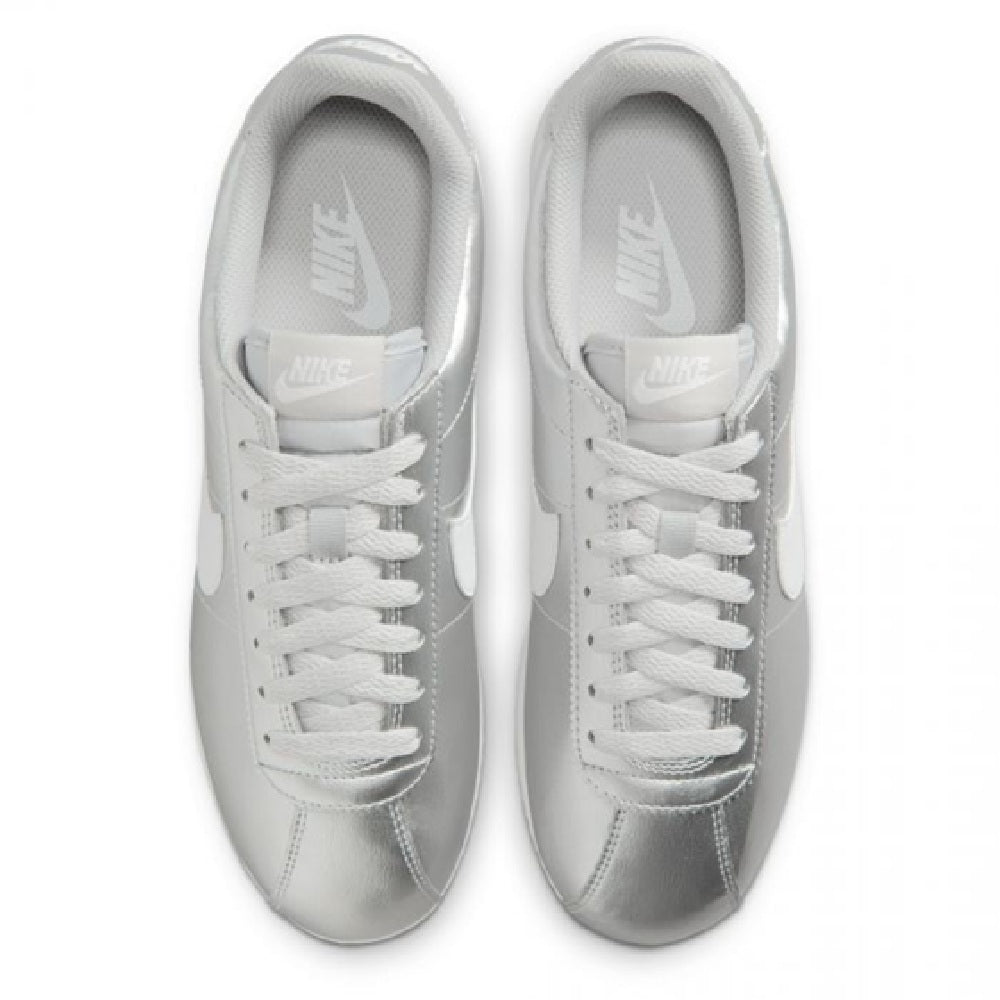 Metallic silver Nike Cortez sneakers with white laces, tongue, and padded collar.