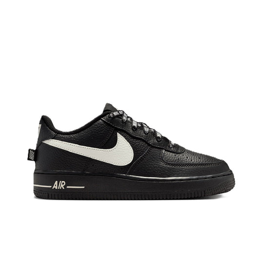 Black low-top Nike sneakers with white swoosh, lace-up, and AIR on sole