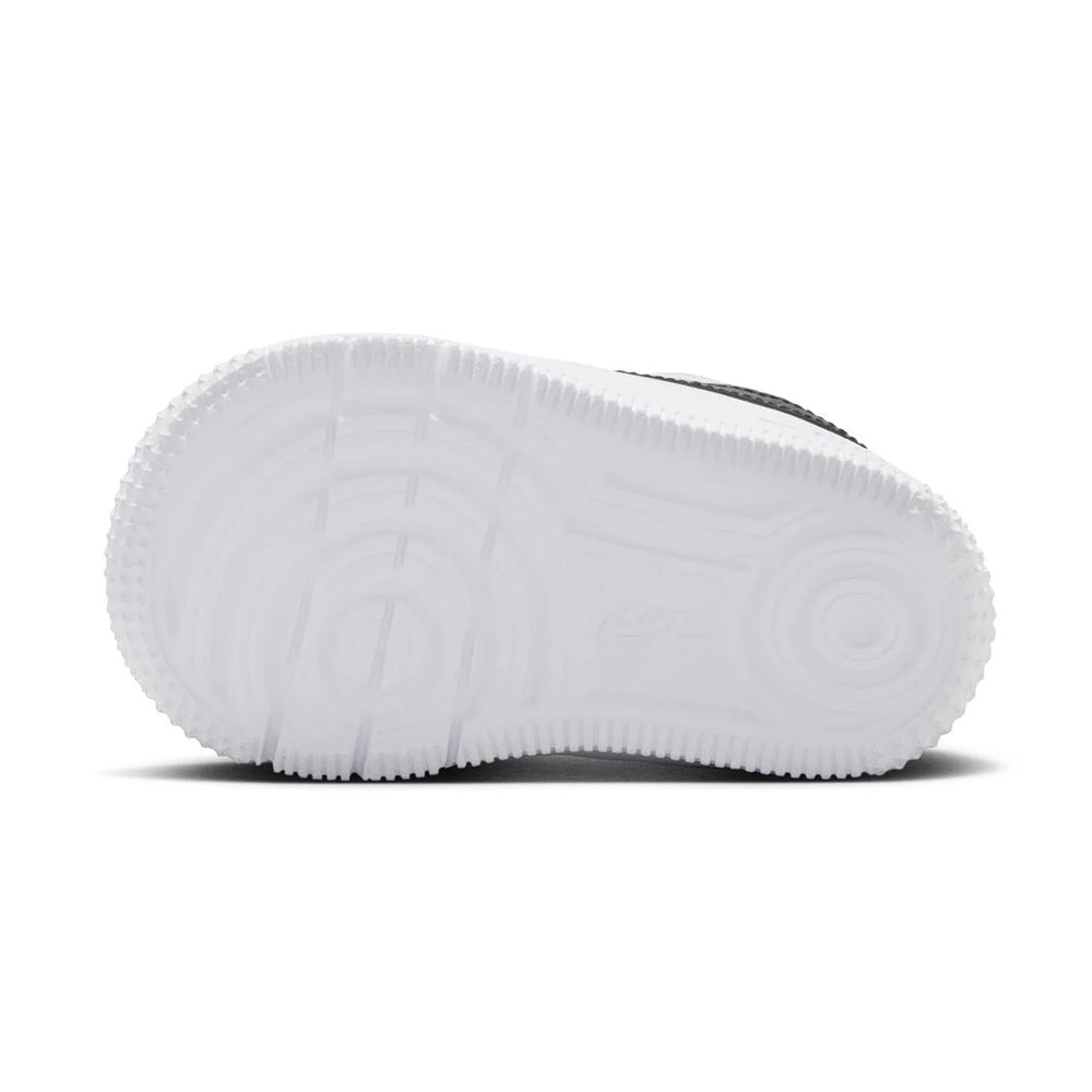 White toddler sneaker outsole with textured tread and grippy sidewall