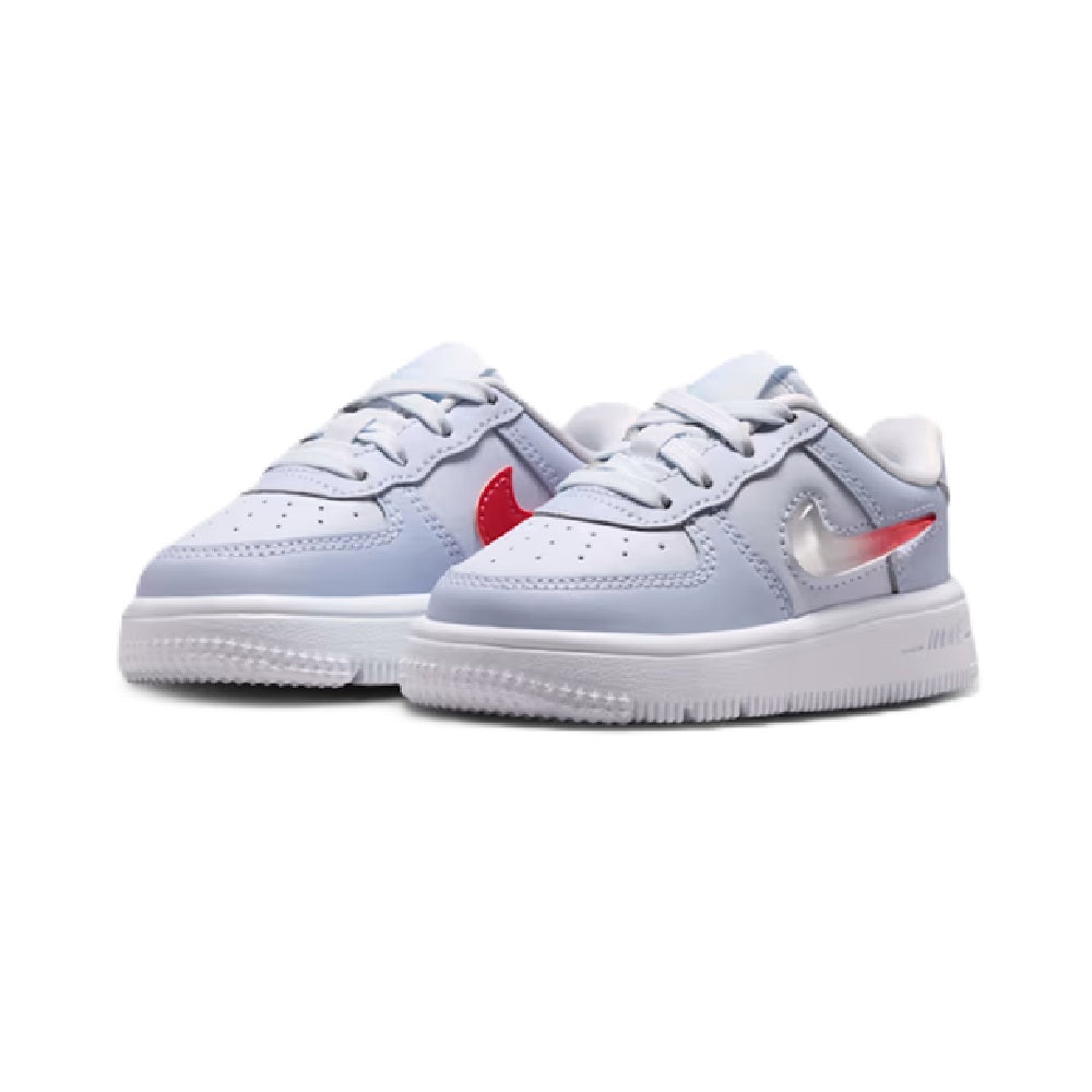 Pair of kids low-top sneakers in light grey with red swoosh accents and white rubber sole