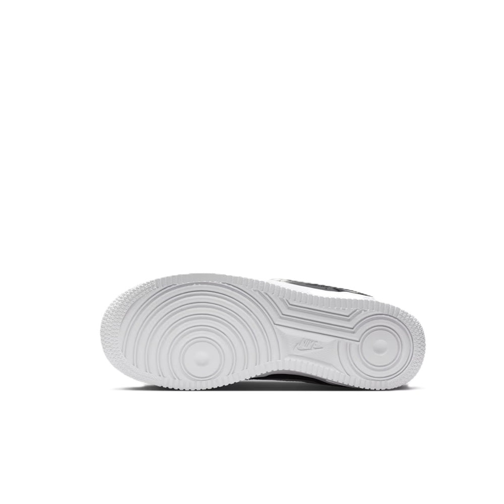 Nike Air Force 1 kids sneaker outsole view, white rubber tread with circular patterns