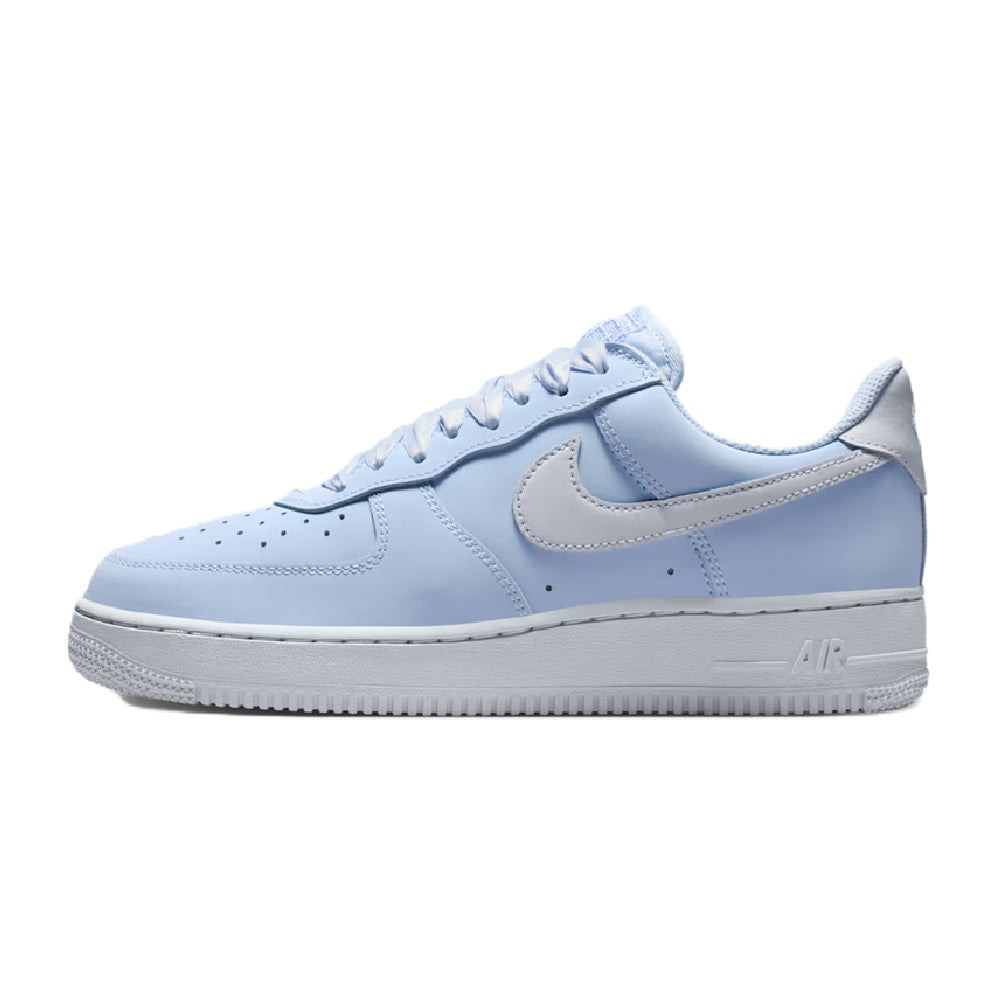 Nike low-top lace-up sneakers with light blue upper, grey Swoosh, and white sole
