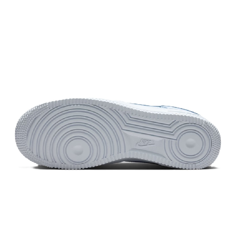 Nike sneaker outsole in light grey with circular traction pattern, heel view