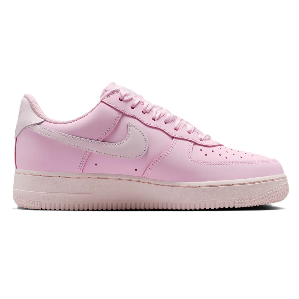 Pink low-top sneakers with Nike swoosh and lace-up front