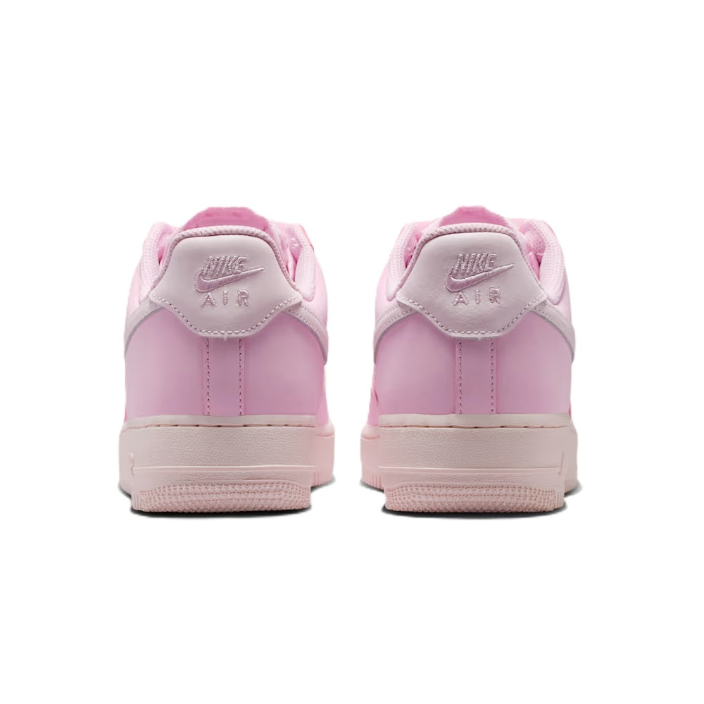 Pink low-top sneakers with Nike Air heel tabs and lace-up back