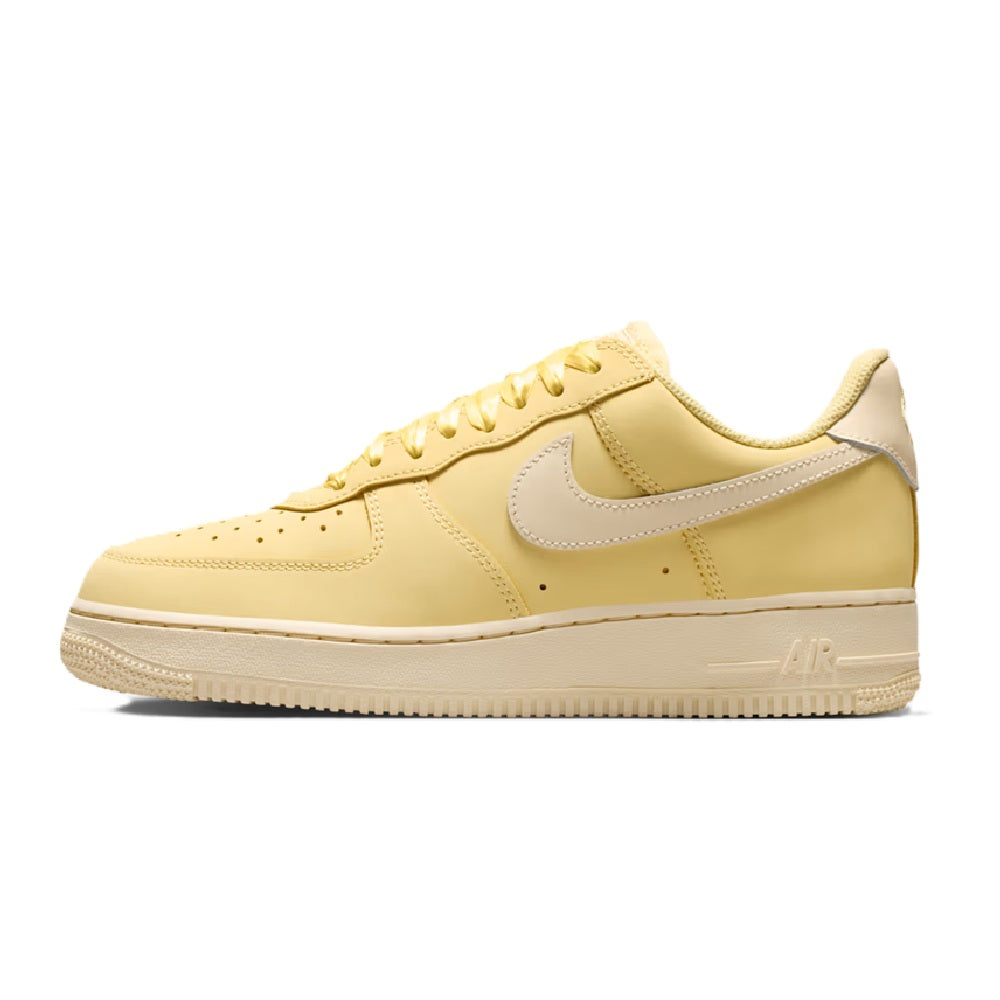 Women's Nike Air Force 1 PRM sneakers, side view in soft yellow and white midsole