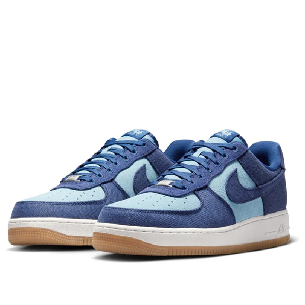 Pair of Nike Air Force 1 low-top sneakers in navy with light blue swoosh and gum sole