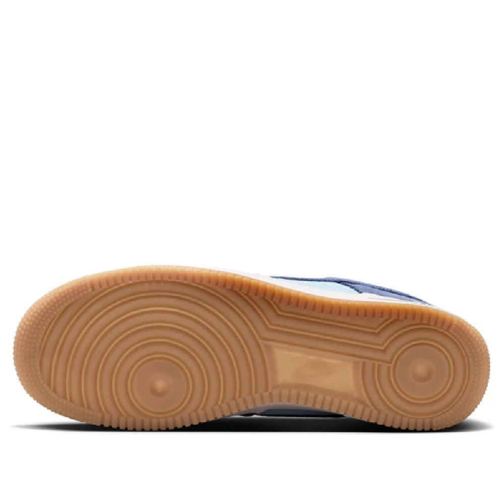 Nike Air Force 1 gum rubber outsole with visible tread pattern in navy sneaker pair