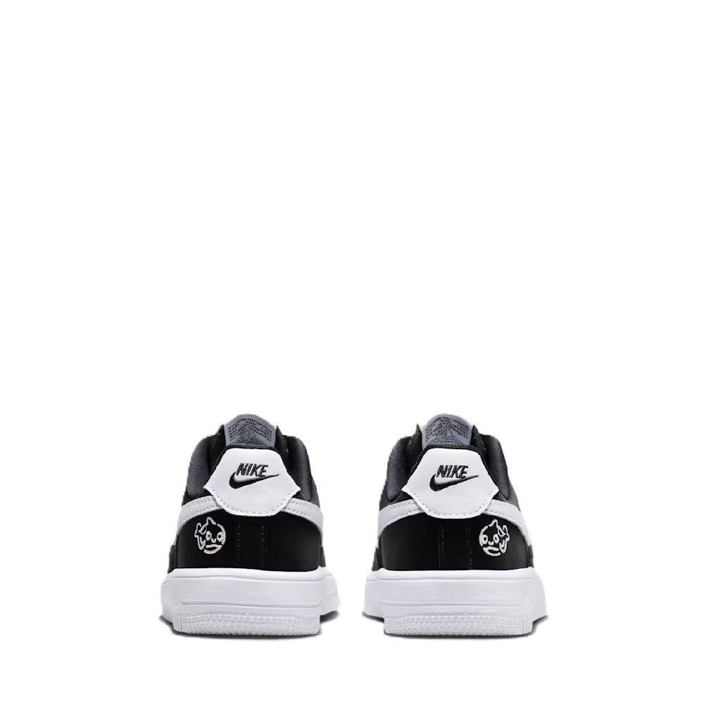Kids black low-top sneakers with white heel tabs and lace-up collar