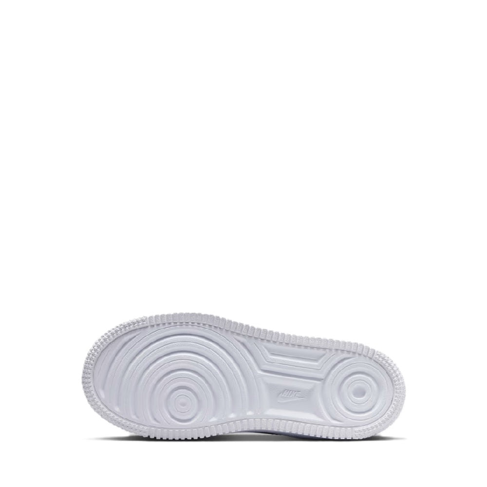 White rubber outsole for black kids low-top sneakers with circular traction pattern