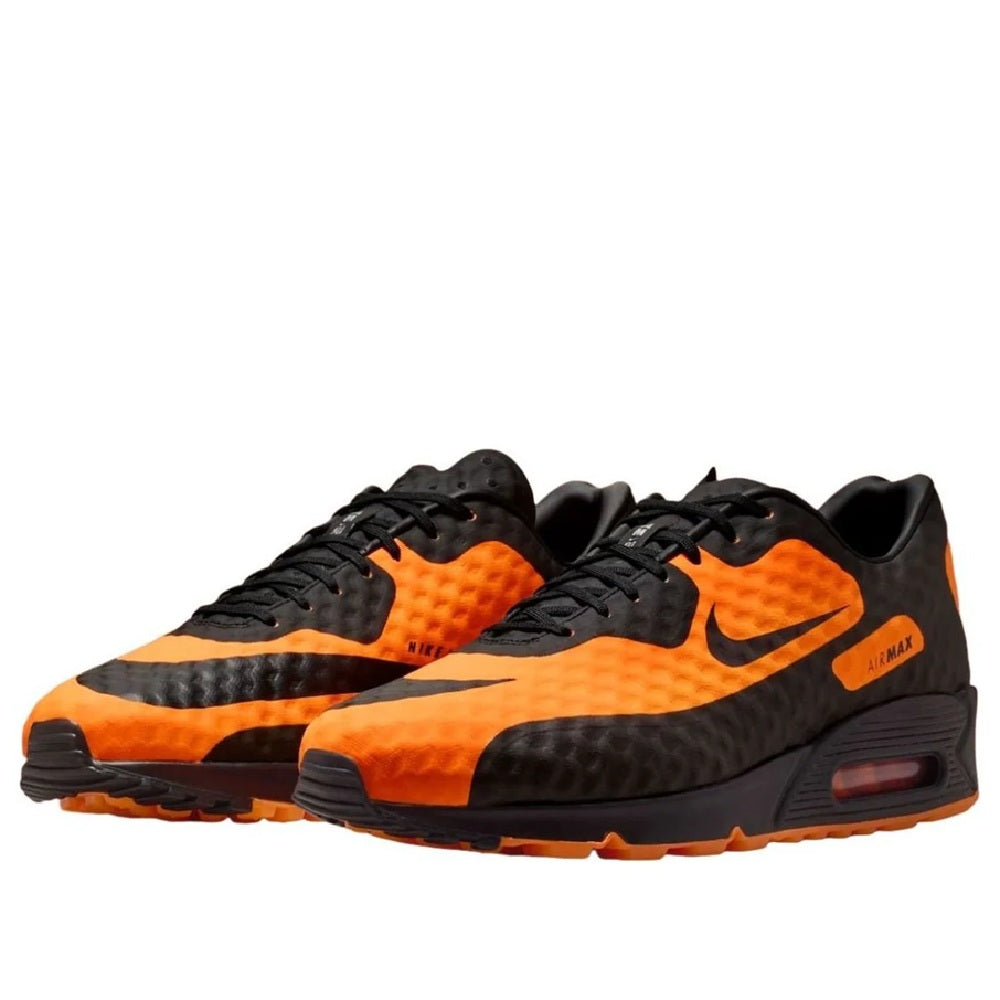 Nike Air Max 90 sneakers pair, black upper with bright orange swoosh and Air cushioning