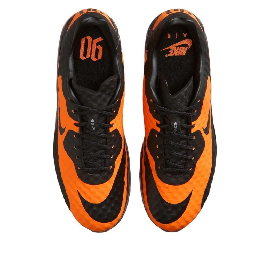 Nike Air Max 90 sneakers, top view with black laces and bright orange panels