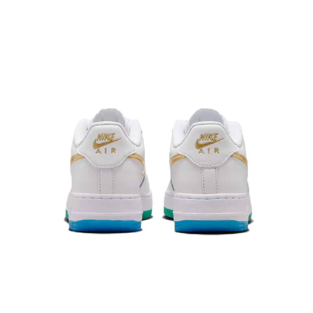 Pair of white sneakers with gold heel tabs, Nike Air logo, and blue outsole