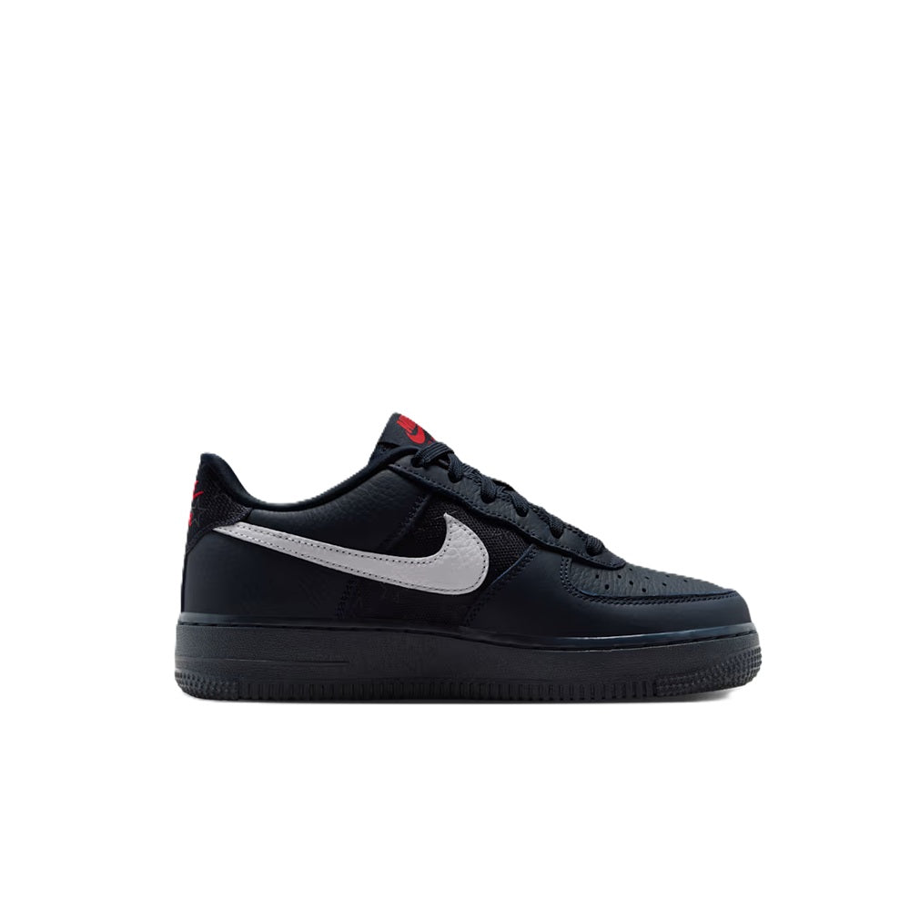Nike Air Force 1 low sneakers, dark navy/black with white swoosh and red heel tab.
