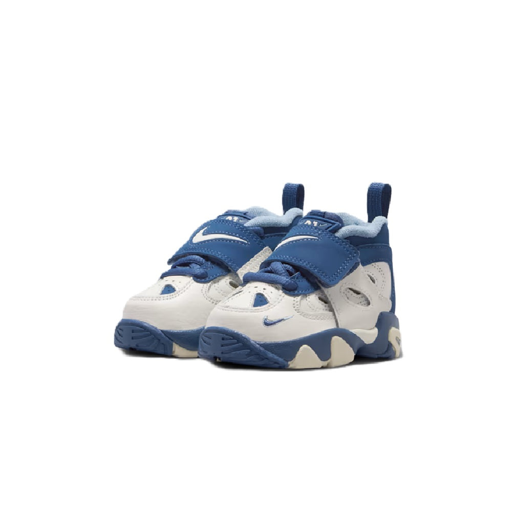 Toddler Nike Air Diamond Turf sneakers front view in blue and sail with padded collar